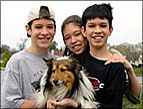 three children two boys one girl and a sheltie dog