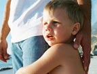 daily Devotion boy hugging dad's leg at beach