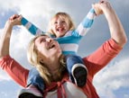 happy mother with child on shoulders