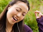 woman singing wearing earbuds