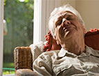 elderly man sleeping with a smile on his face