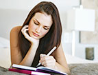 young woman writing in journal